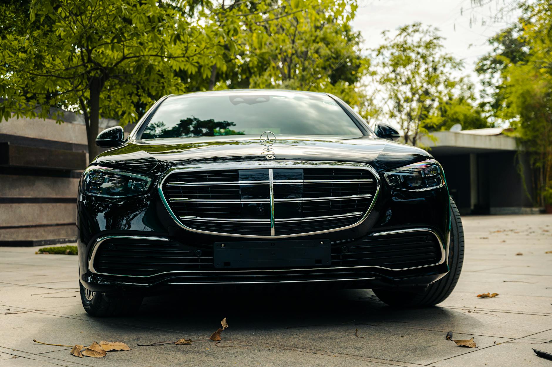 Czarny luksusowy Mercedes z przodu zaparkowany w spokojnej scenerii pleneru